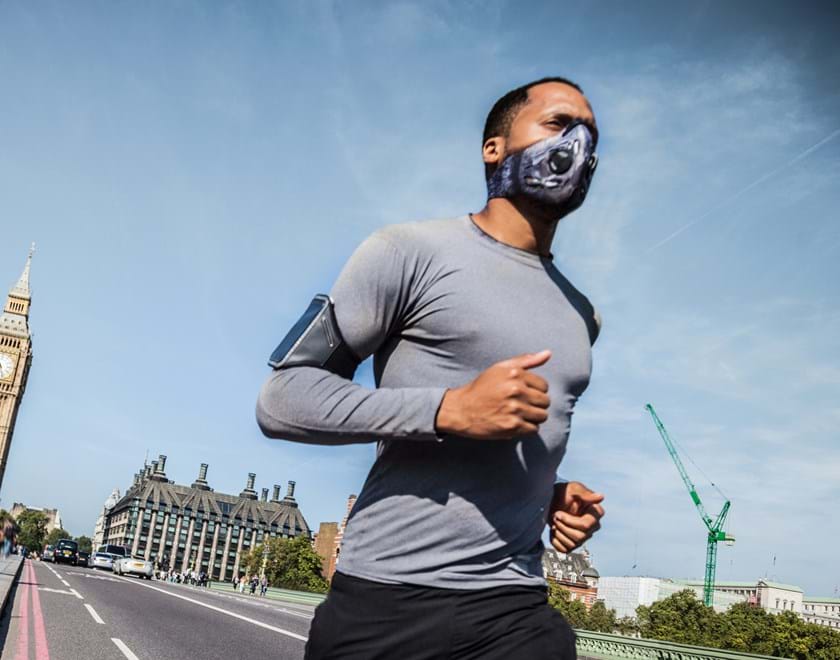 Man running across Westminster Bridge with mask on